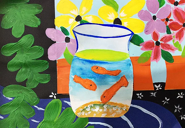 Painted goldfish in a glass jug, surrounded by flowers and green leaves.